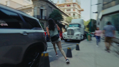 a woman is skateboarding down a busy street