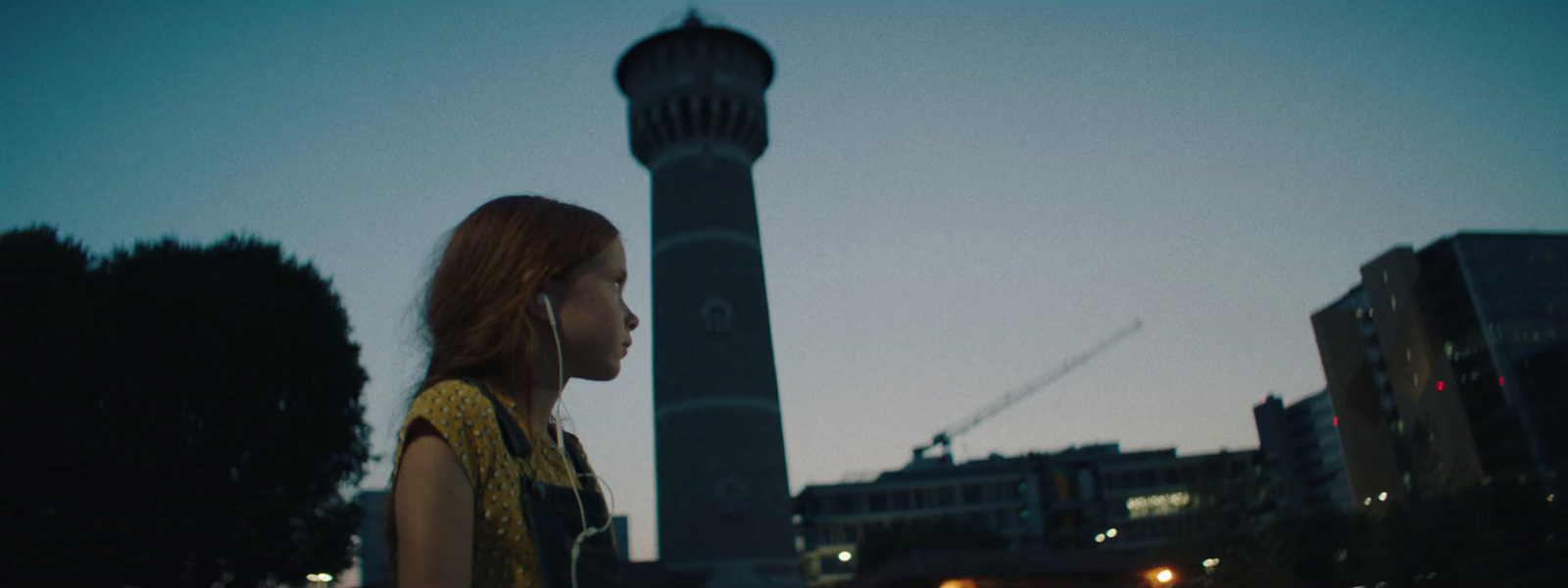 a woman standing in front of a tall tower