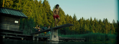 a man standing on top of a wooden dock