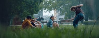 a group of people sitting in the grass