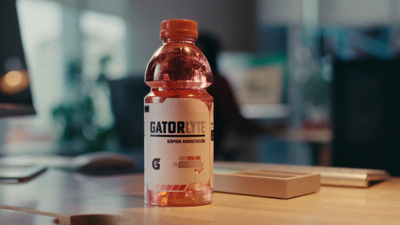 a bottle of gatorade sitting on a table