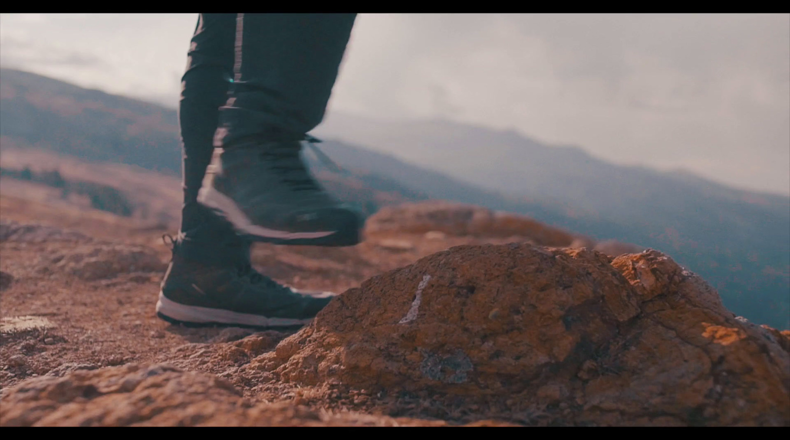 a person standing on top of a rocky mountain