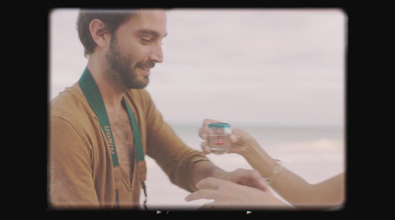 a man holding a woman's hand and a jar of water