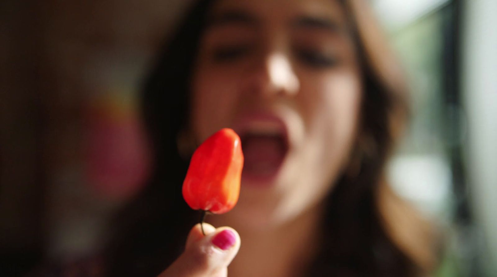 a woman holding a piece of food in her hand