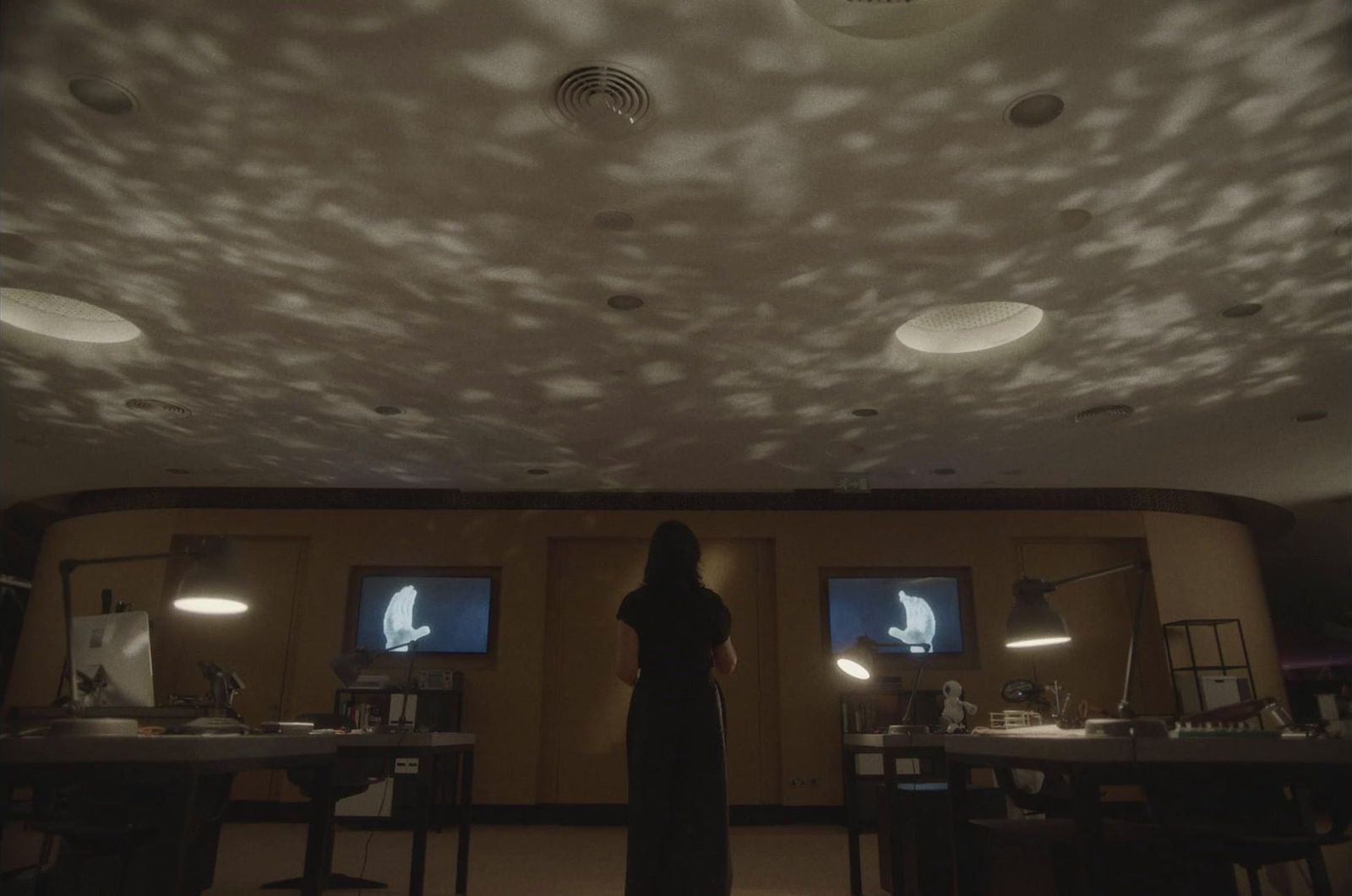 a woman is standing in a dimly lit room