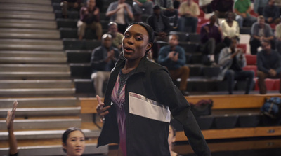 a woman standing in front of a crowd of people