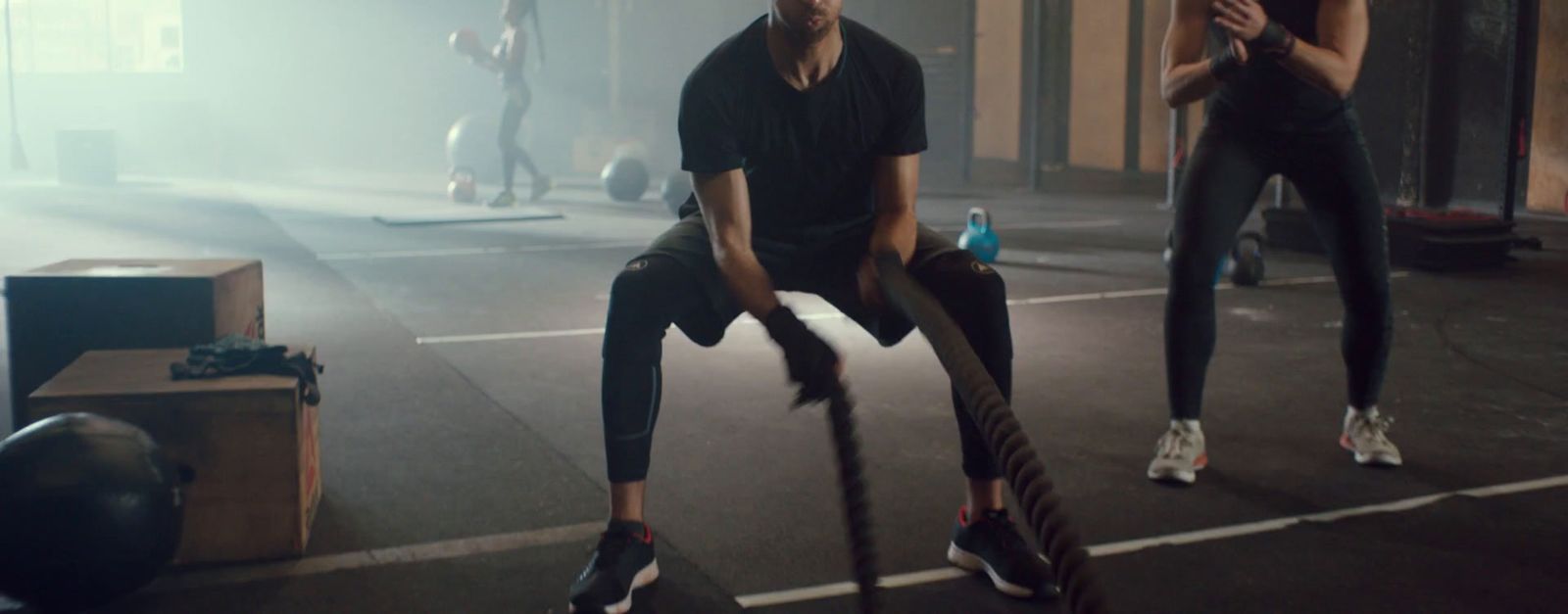 a man and a woman doing exercises in a gym