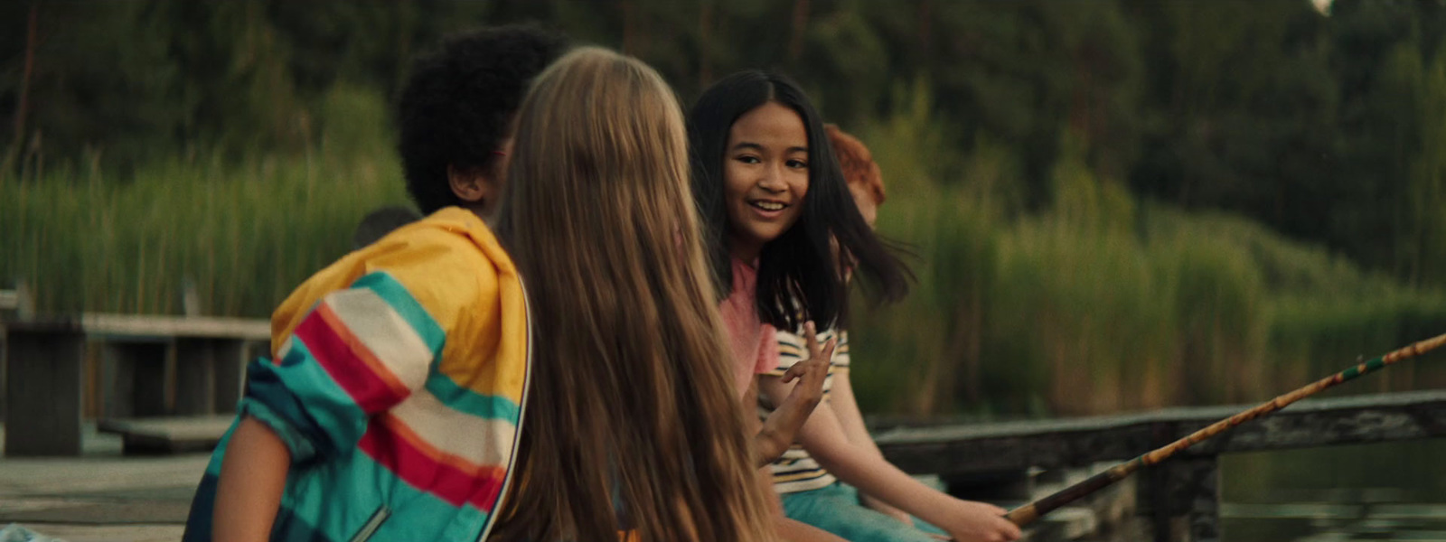 a group of young people sitting on top of a boat