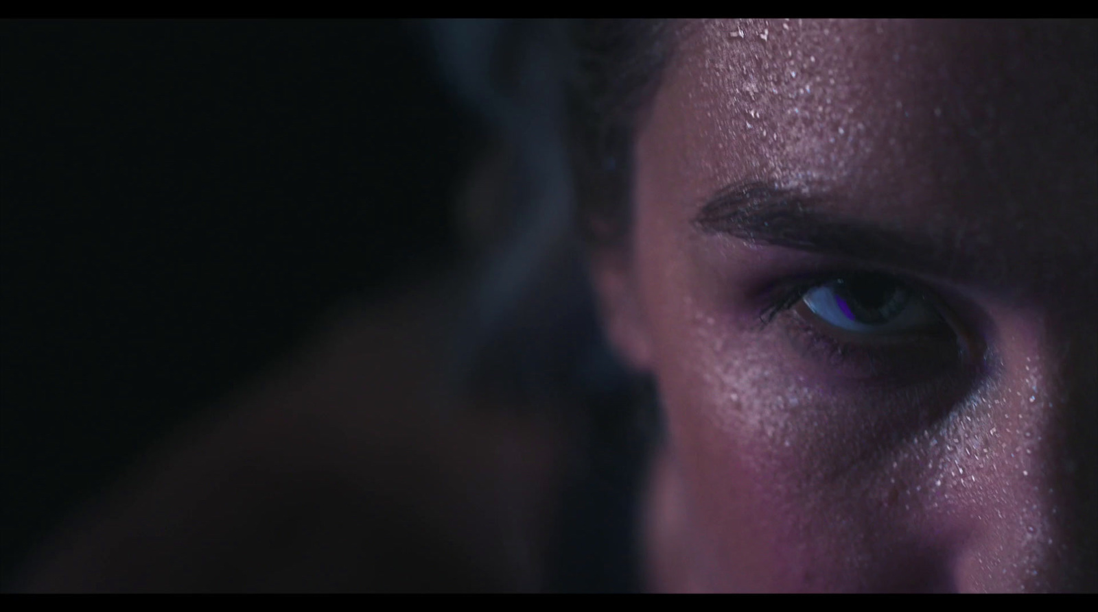 a close up of a man's face with blue eyes