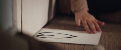 a person's hand on top of a piece of paper