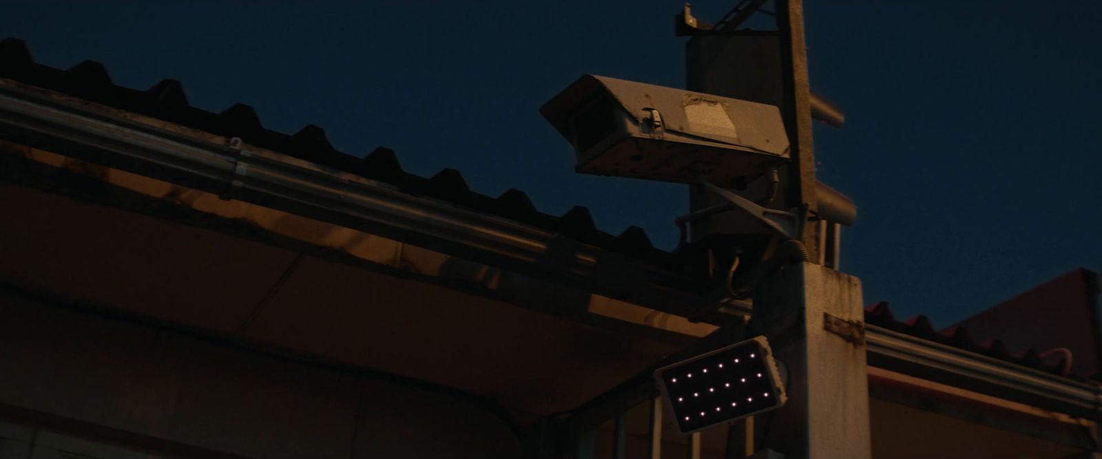 a street sign on a pole with a building in the background