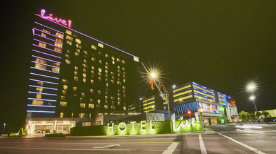 a night view of a hotel and a traffic light