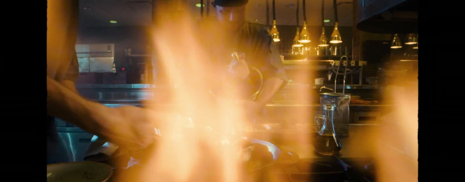 a blurry image of a person cooking in a kitchen