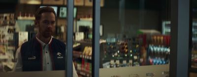 a man standing in front of a store window