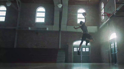 a person jumping in the air with a basketball