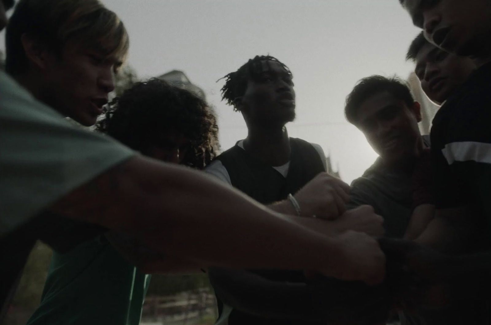 a group of young men standing around each other