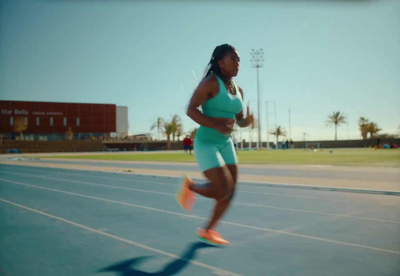 a woman running on a running track