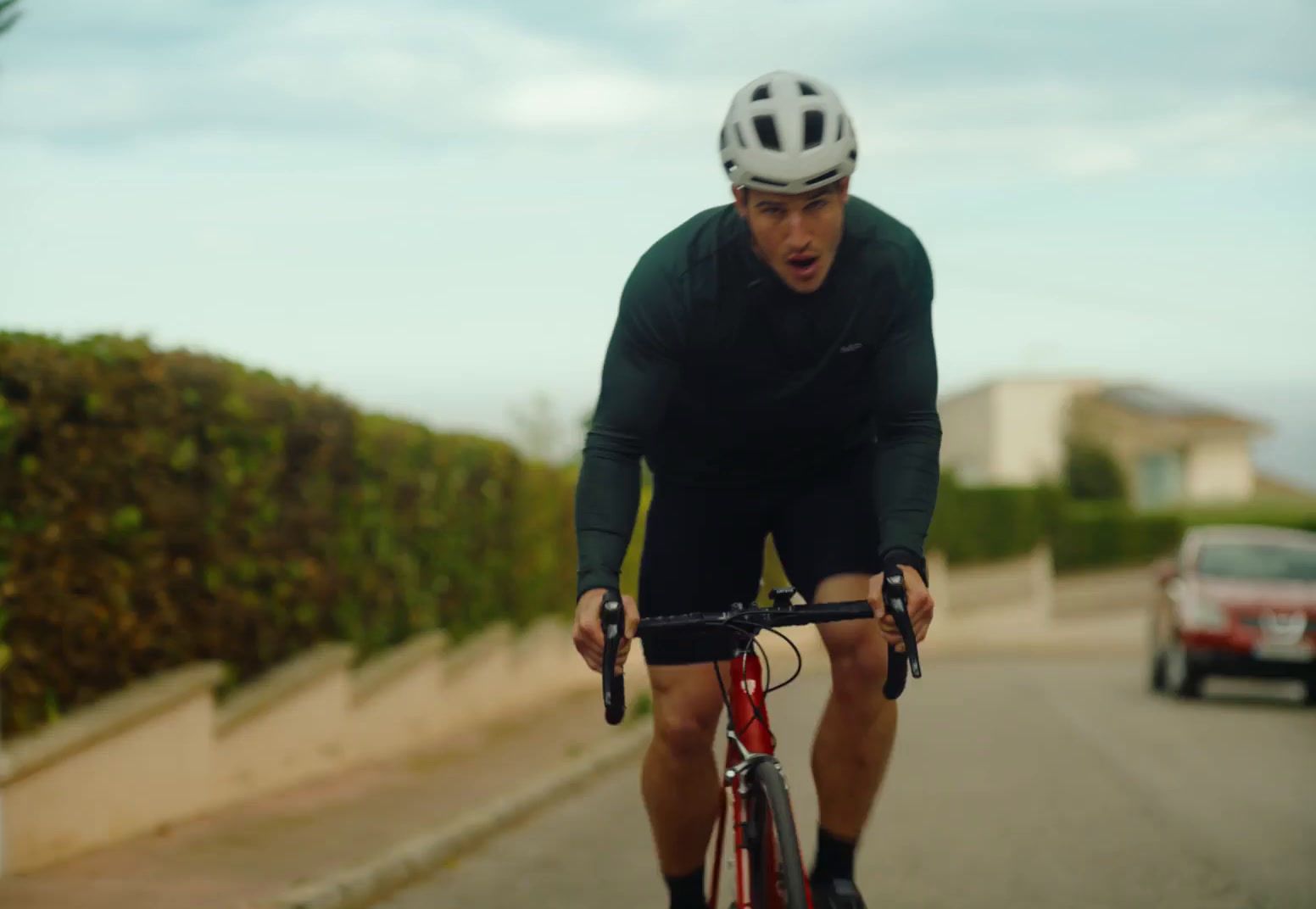 a man riding a bike down a street