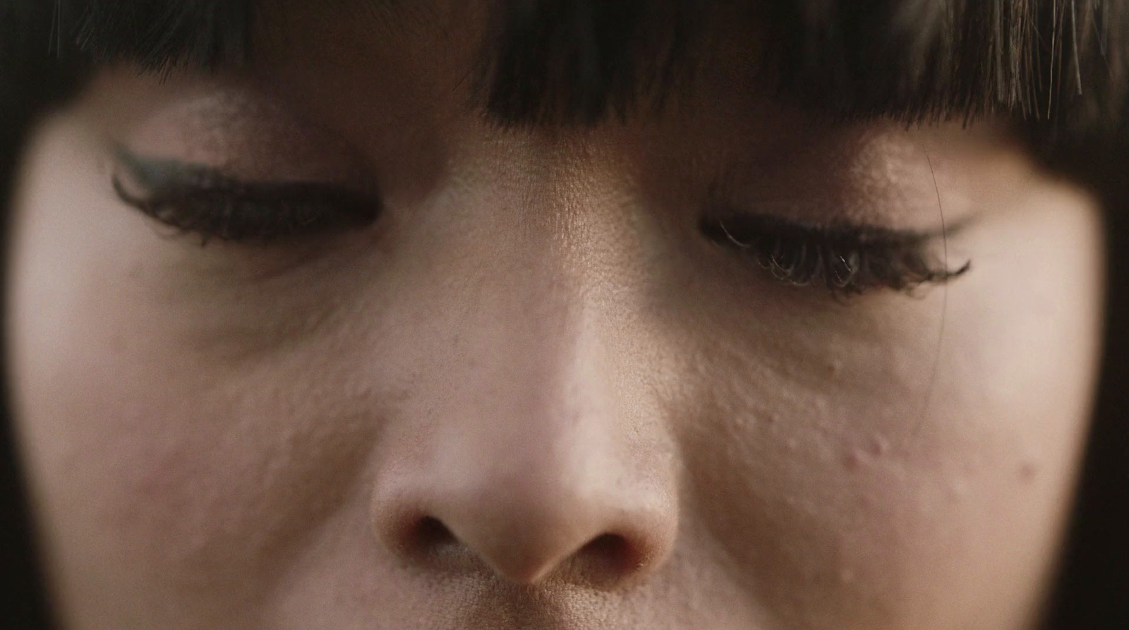 a close up of a woman's face with her eyes closed