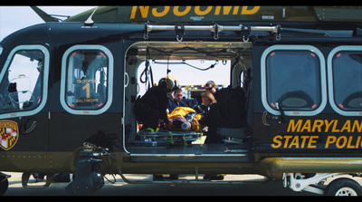 a group of people standing in the back of a helicopter