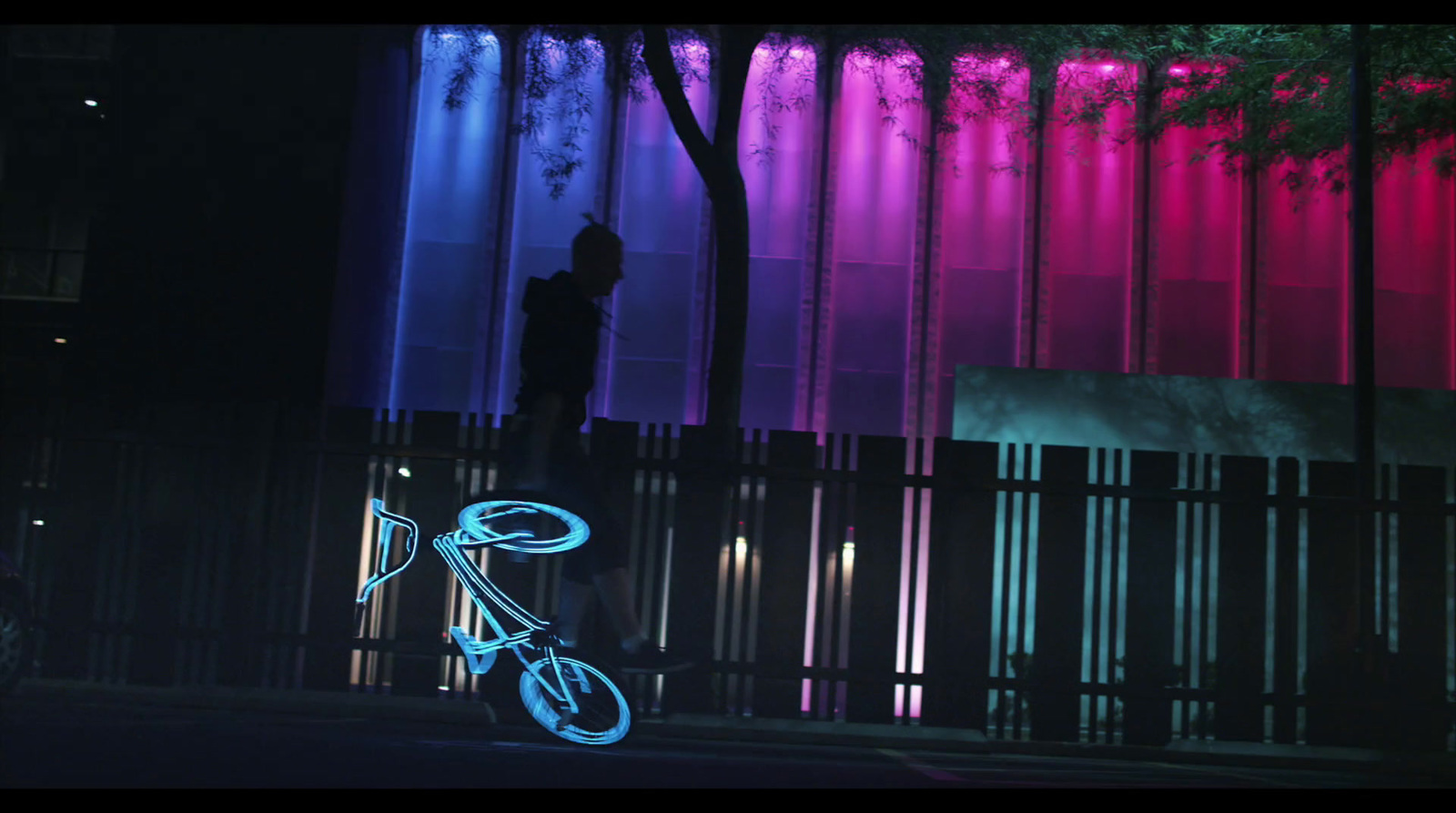 a bicycle parked in front of a tall building