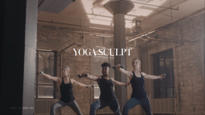 a group of people doing yoga in a room