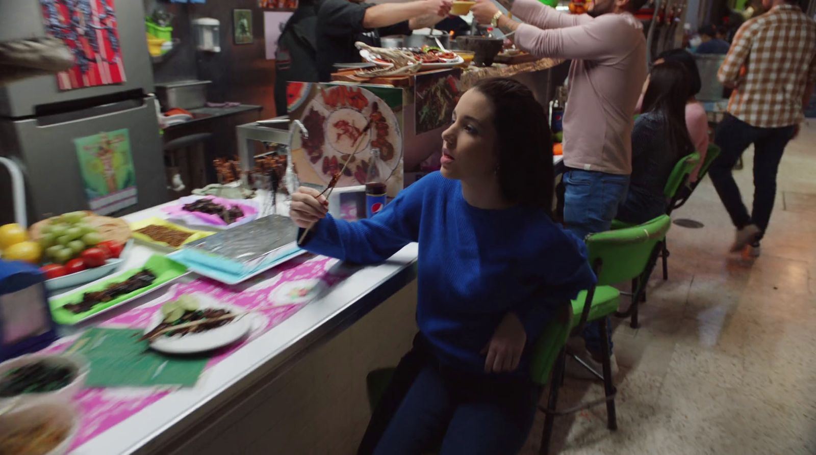 a woman sitting at a table with a glass of wine