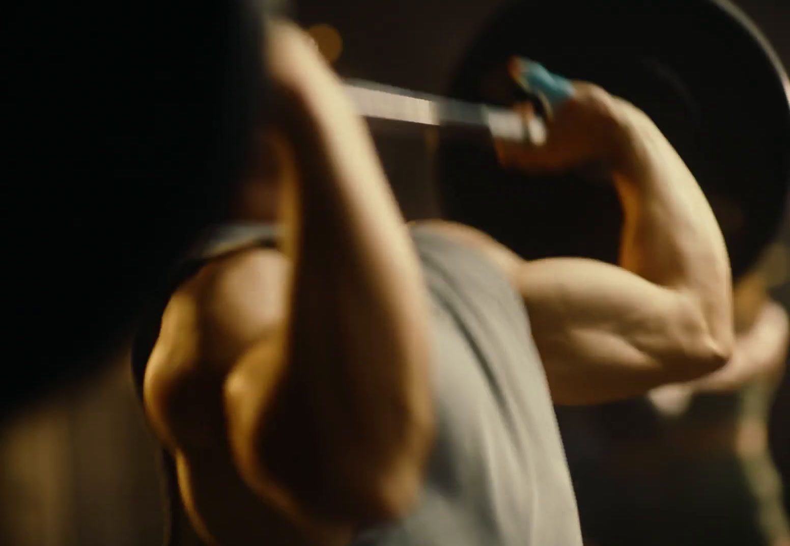 a man lifting a barbell in a gym