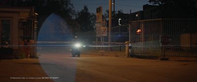 a car driving down a street at night