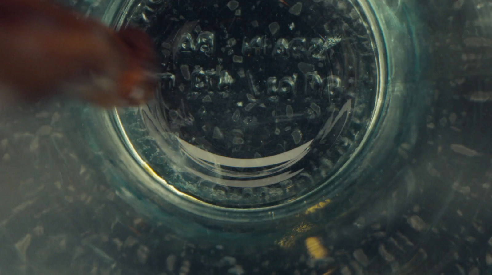 a person pouring water into a glass