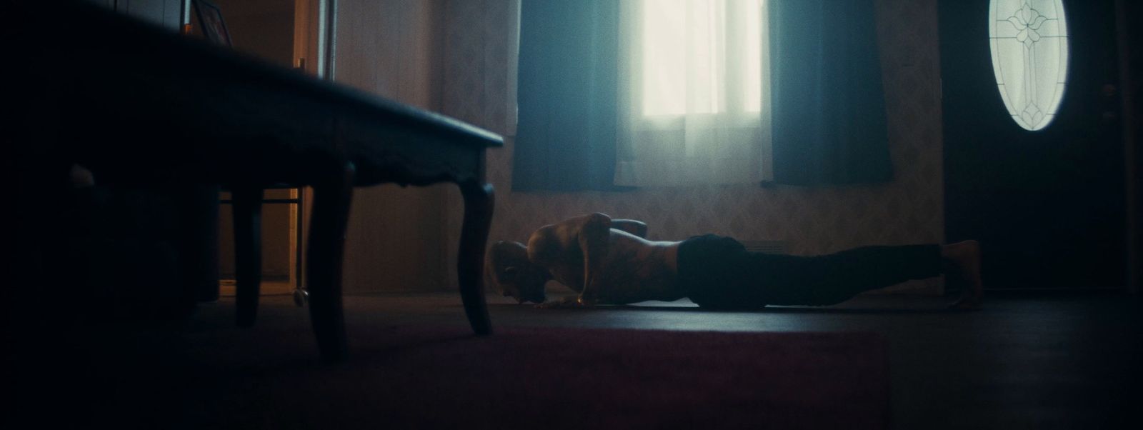 a woman laying on the floor in a dark room