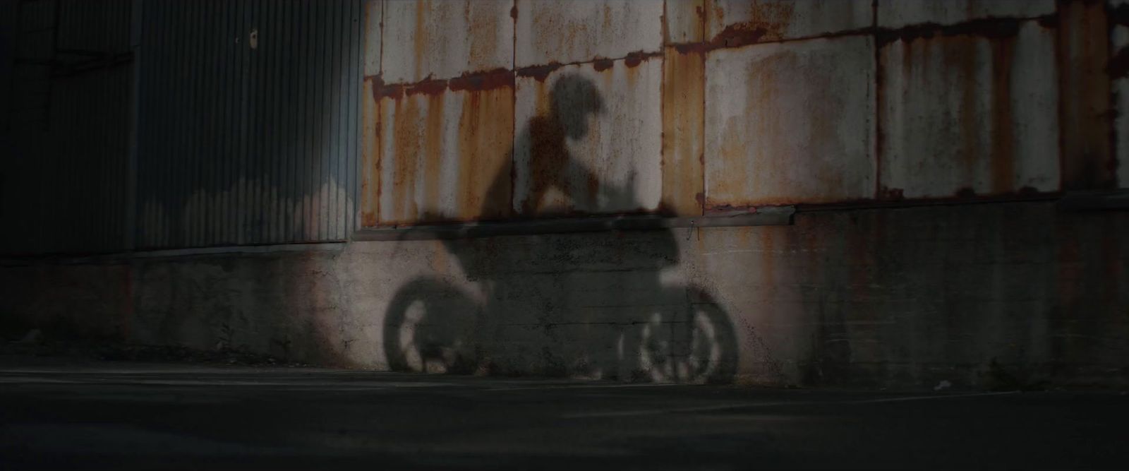 a shadow of a person on a bike