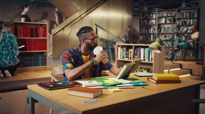 a man sitting at a desk in a library