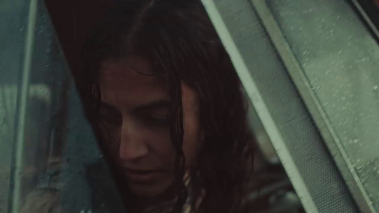 a woman sitting in a car looking out the window