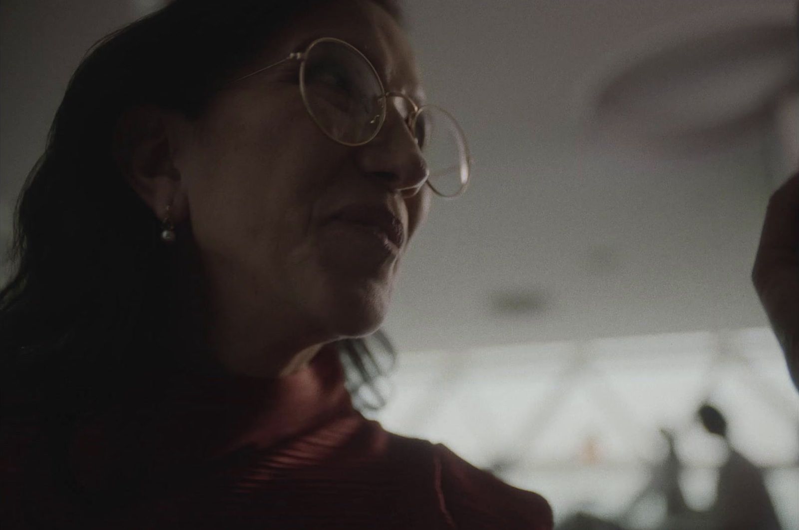 a woman wearing glasses and a red shirt