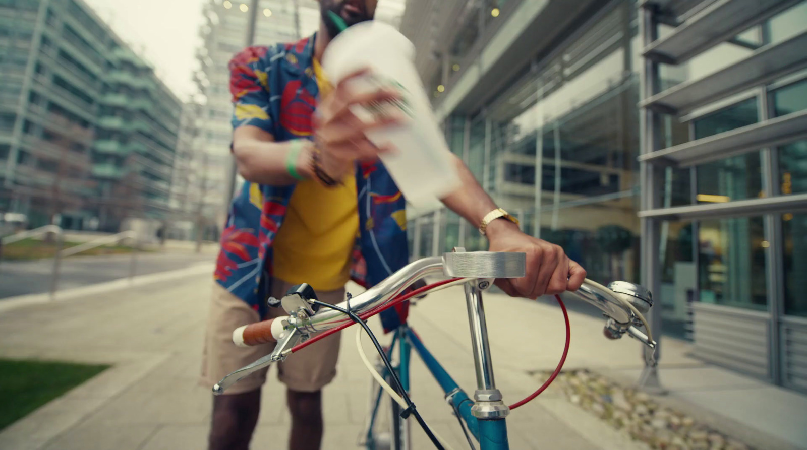 a man is riding a bicycle with a bottle on it