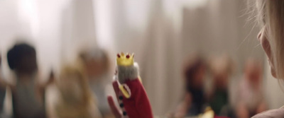 a little girl holding a toy with a crown on it