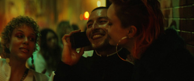 a man talking on a cell phone next to a woman