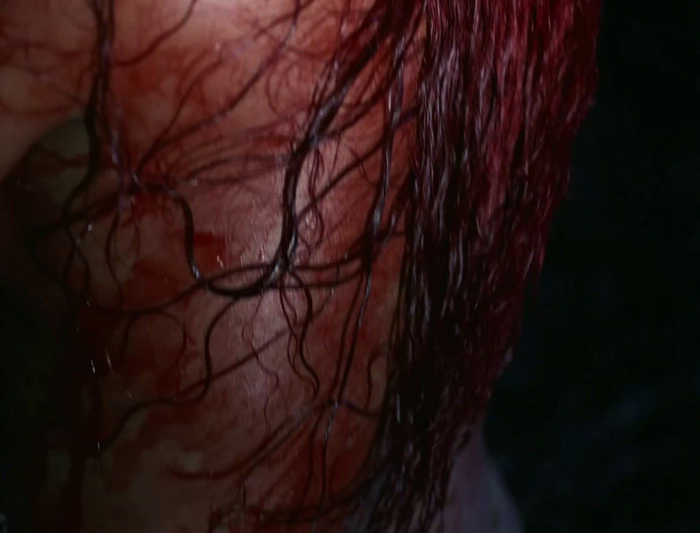 a close up of a person's head with red hair