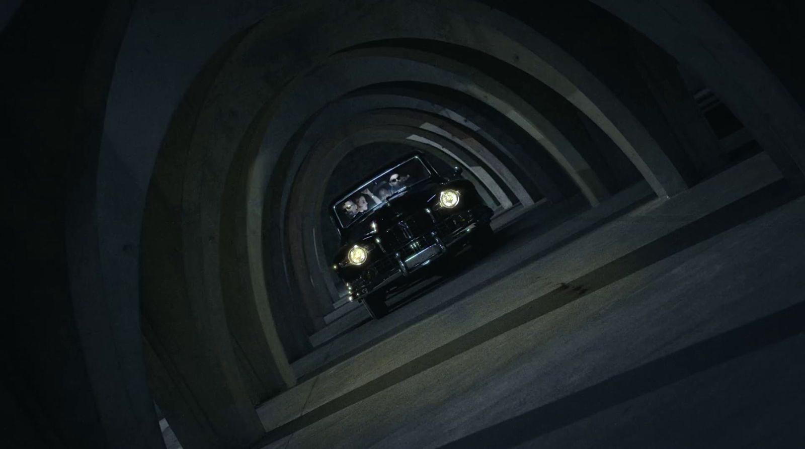 a car driving through a tunnel in the dark