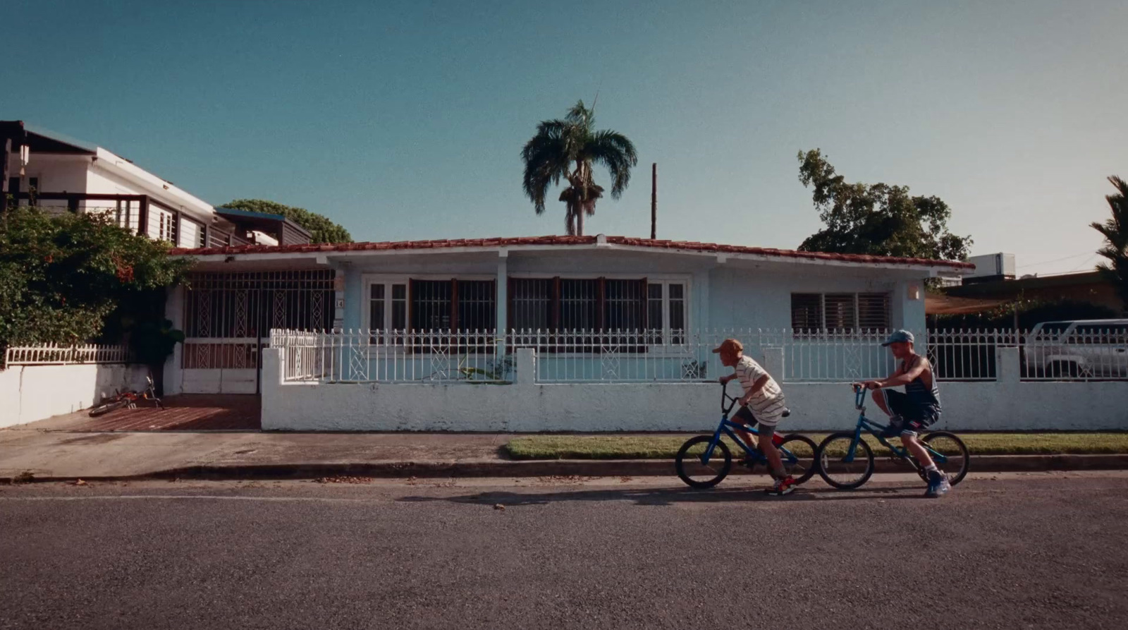 a couple of people riding bikes down a street