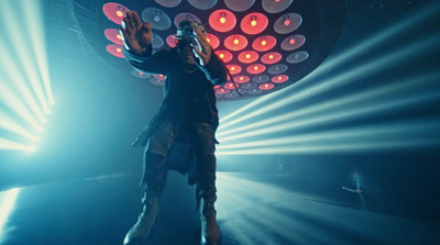 a man standing on top of a stage holding a microphone