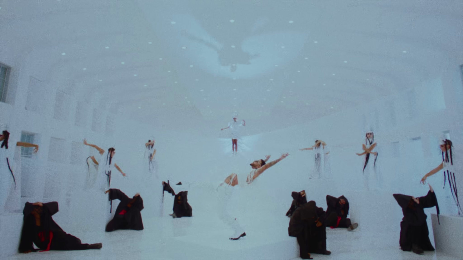 a group of people standing in a white room