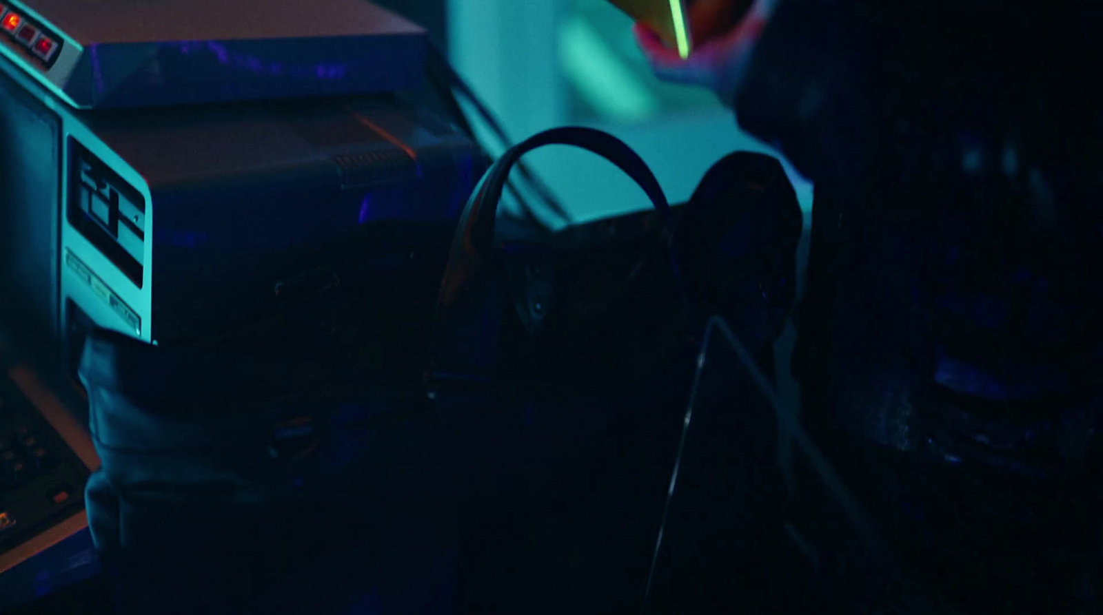 a close up of a radio and a bag on a table