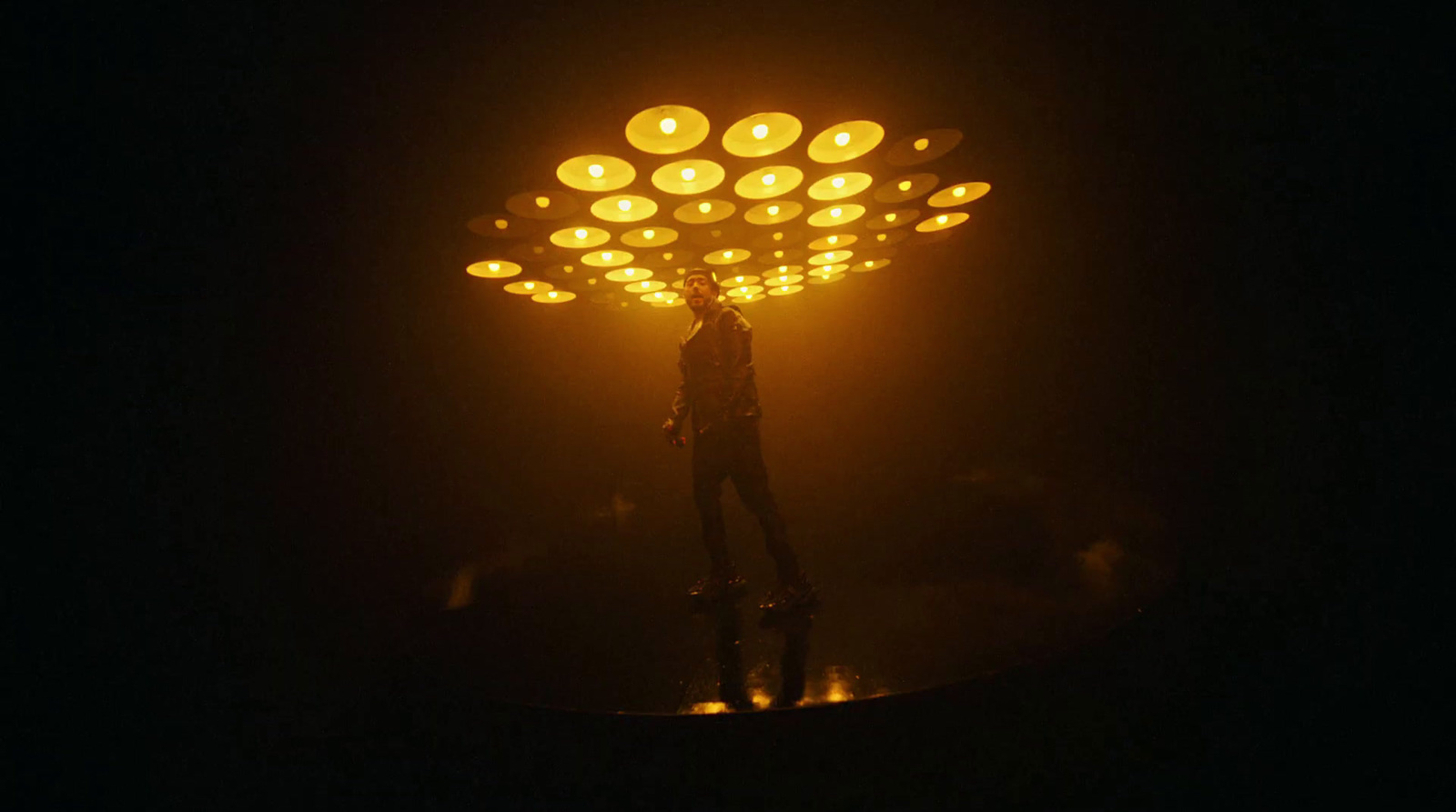 a person standing under a street light in the dark