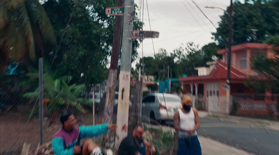 a group of people standing on the side of a road