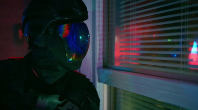 a man in a dark room with a helmet and goggles on