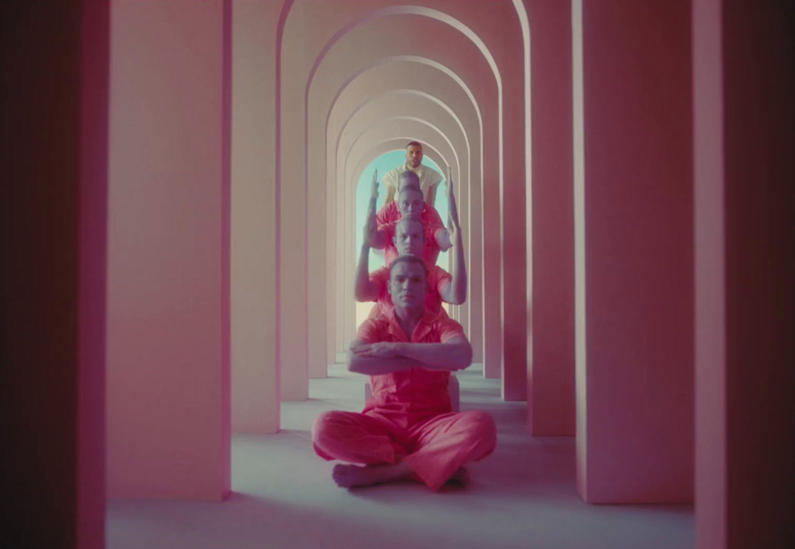 a woman sitting on the floor in a pink room