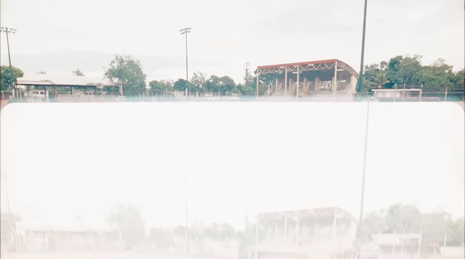 a blurry photo of a building and a field