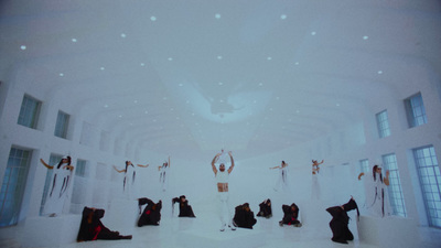 a group of people standing in a white room